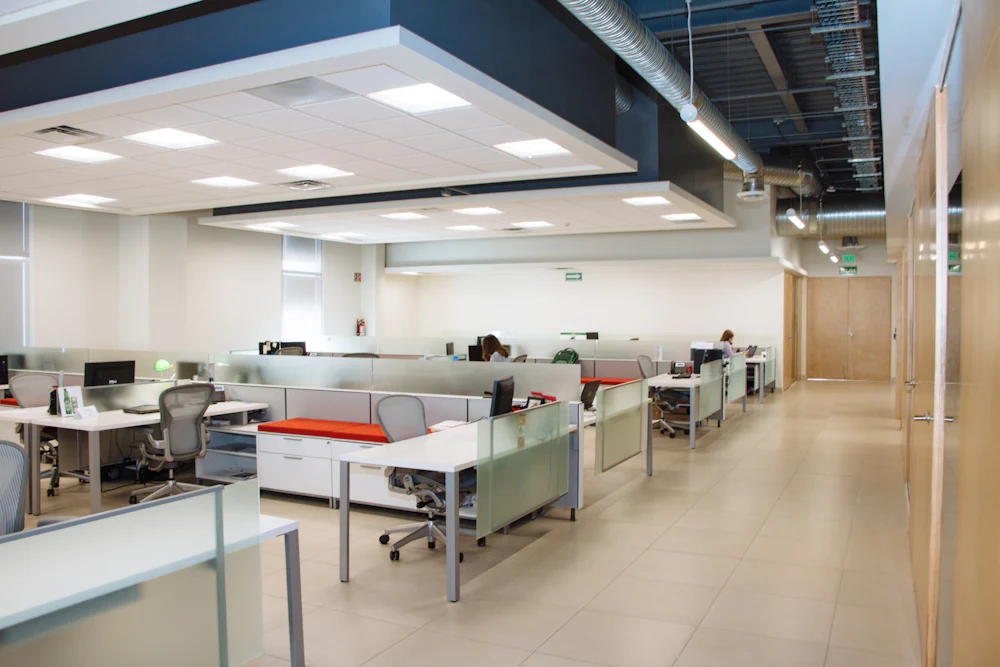 Clean open-plan office with workstations and tile floors